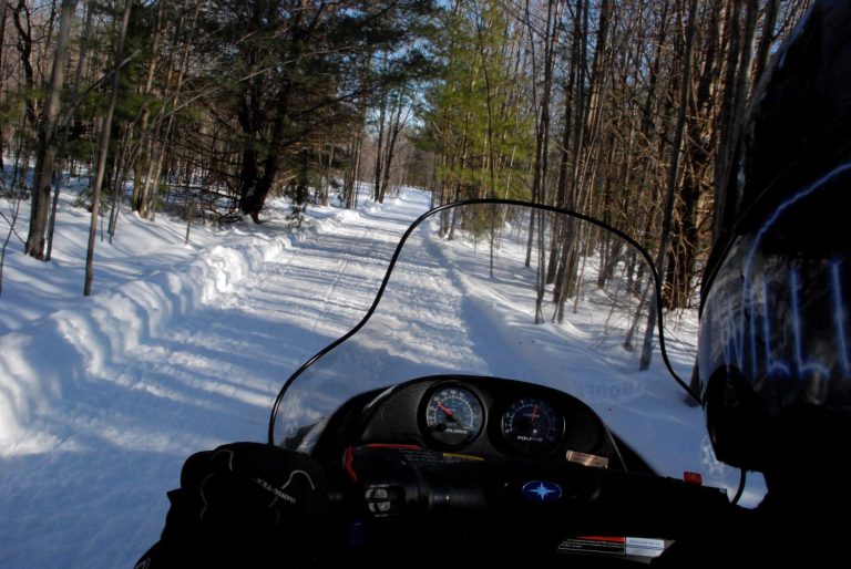 First Person Point of View Snowmobiling down Trail in Oneida County, NY