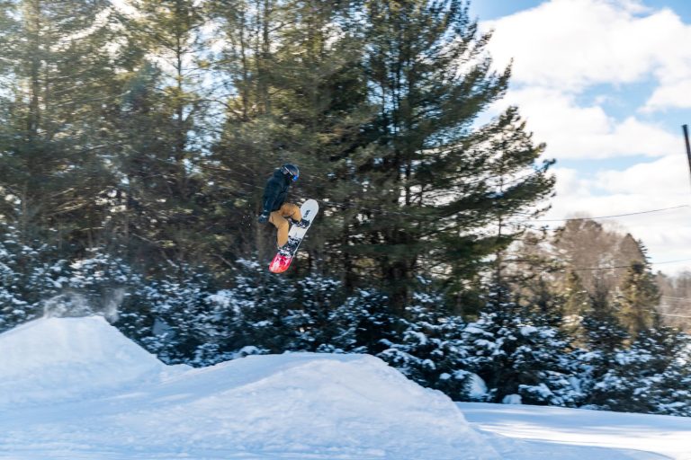 Snowboarder at Woods Valley Ski Area in Westerville, NY getting epic air on a jump.